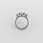 3 stone diamond ring on a light gray background
