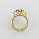 Gold ring with 3 diamonds on a light gray background