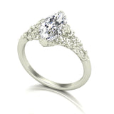 white gold and silver ring with a large diamond and smaller diamonds on the sides against a white background