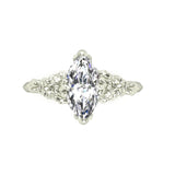 Silver ring with a marquise-shaped diamond on a white background