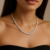 Diamond necklace worn by a model in a black dress against a neutral background