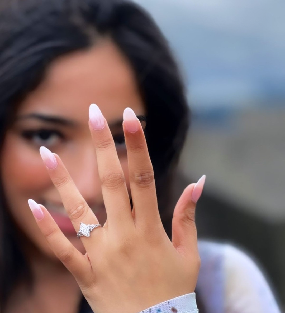 Marquise diamond ring on a ladies hand with black hair 