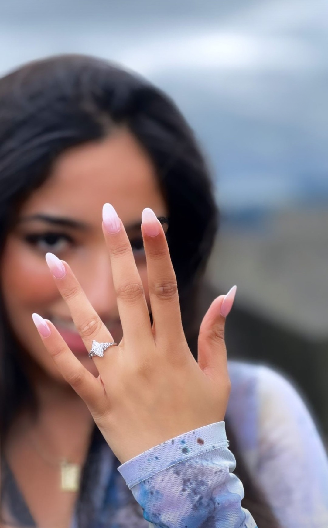 Marquise diamond ring on a ladies hand with black hair 