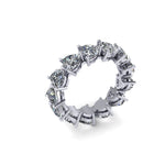 Platinum and silver eternity ring with heart shaped diamond stones on a white background