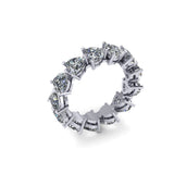 Platinum and silver eternity ring with heart shaped diamond stones on a white background