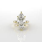 18k yellow gold ring with a marquise-shaped diamond on a white background