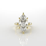 18k yellow gold ring with a marquise-shaped diamond on a white background
