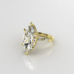 Gold ring with a large marquise-shaped diamond with marquise diamond shoulders band 