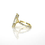 18k yellow gold ring with diamond accents with diamonds on the bezel on a white background