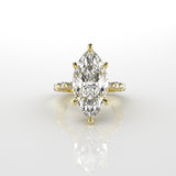 Gold ring with a marquise-shaped diamond with 6 claws on a white background