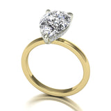 18k gold ring with a pear-shaped diamond on a white background