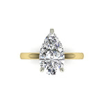 Gold and platinum teardrop-shaped diamond ring on a white background
