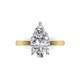 Gold and platinum teardrop-shaped diamond ring on a white background