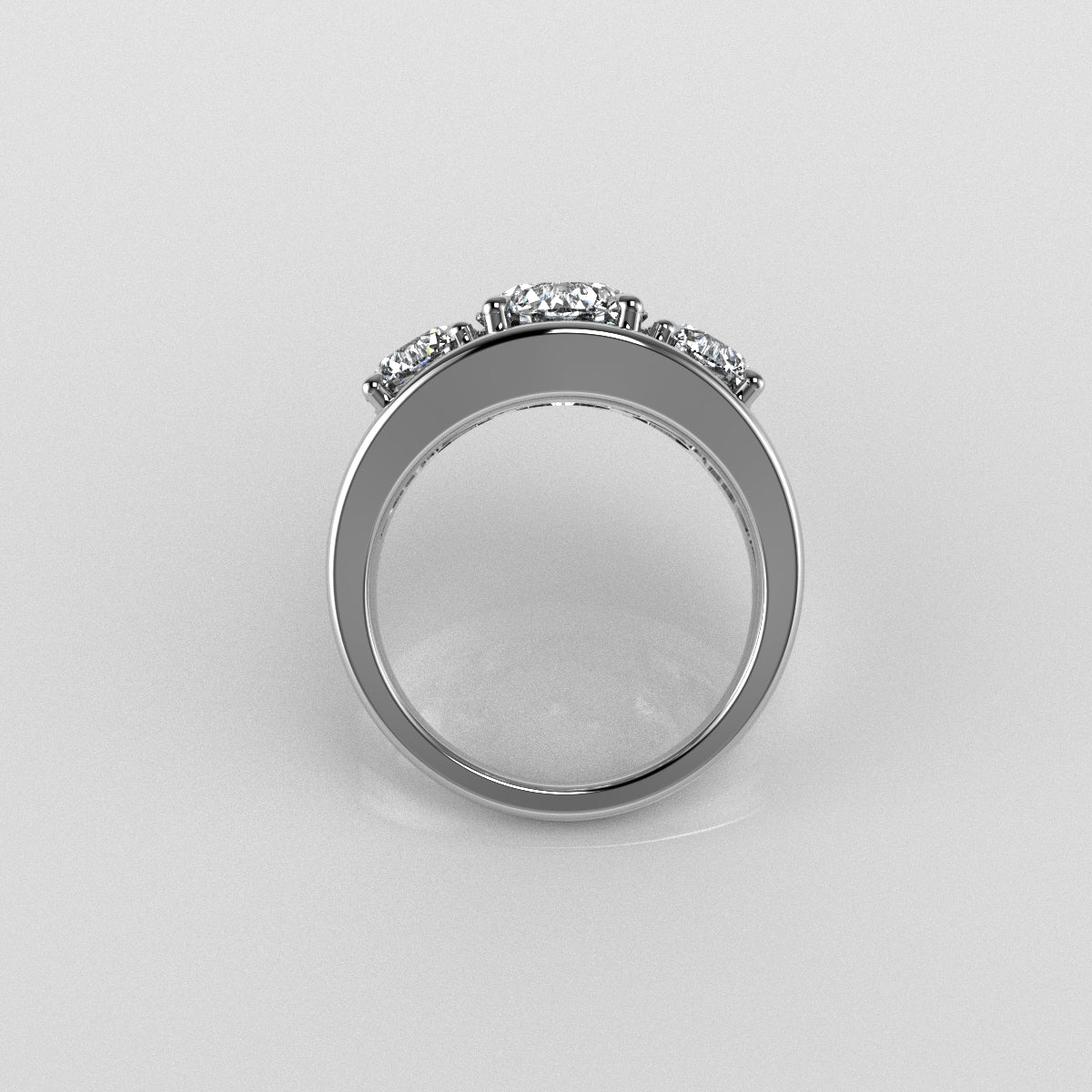 18k white gold three stone round brilliant cut diamond ring on a light gray background