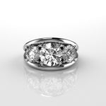 three stone round brilliant cut diamond ring on a reflective surface with a white background