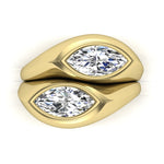 18k yellow gold ring with two marquise-shaped diamond stones on a white background