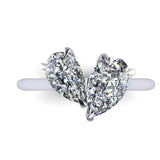 Pair of pear shaped diamond in a platinum ring on a white background